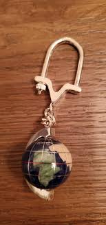 Cherished Tails Senior Sanctuary - 413: Semi Precious Globe Key Chain. Semi-Precious Stones make this World Globe Key Ring makes a perfect gift for that special someone!!!! It has Snowflake Obsidian, Howlite,