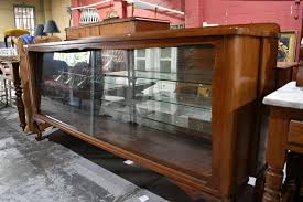 Sold at Auction: Vintage cedar sideboard / display buffet on carved cabriole legs, sliding glass doors, mirror back with 3 glass adjustable shelves. Overall height 97cm x 203cm wide x 45cm deep.