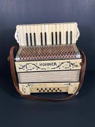 LOT 185: Vintage Hohner Accordion in Case | EstateSales.org
