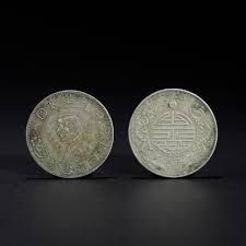 Sold at Auction: TWO SILVER COINS WITH DISTINCTIVE DESIGNS