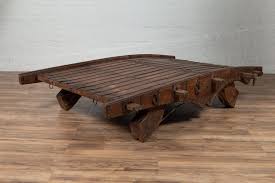 Indian Rustic Antique Wooden Ox Cart with Metal Accents Made into a Coffee Table at 1stDibs | indian ox cart coffee table, ox cart table, bullock cart wheel coffee table