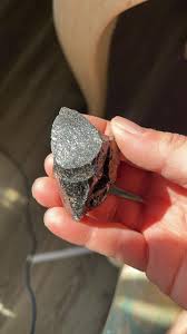 What is the identity of the shiny rock/mineral found in a yard near Lake Erie in Elyria, OH?