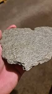 Found in Scottish Highlands, 20 miles north of Inverness, glittery, light and when rubbed leaves silver residue on fingers : r/whatsthisrock