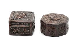 At Auction: Two carved and repousse' silver covered boxes, decorated with phoenix and flowers