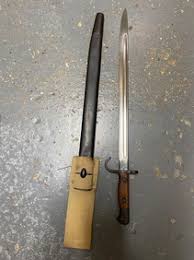 A Rare British 1907 Hooked Quillon Bayonet With Scabbard. The Blade Is Dated 1913. It Has Original