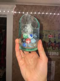 My marble collection! I found while digging for bottles. I mostly keep them in a broken in half bottle I repurposed. : r/Marbles