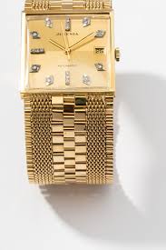 Lot - Juvenia 18 Karat Yellow Gold and Diamond Calendar Watch
