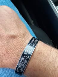 What does the black band on the wrist represent?