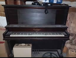 What is the value of this antique piano in its current ...