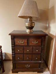 Tall dresser with brass lamp | EstateSales.org