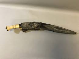 An antique highly decorative sheath & kukri knife; bone ...