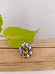 Antique platinum finish ring with teardrop yellow topaz surrounded wit – divakaari