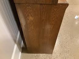 Lot - Oak four door stove display cabinet with sliding glass doors, 72” x 16.5” x 88”. Has split on side. Wear to finish.