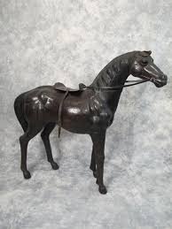 Sold at Auction: Old leather on wood horse statue