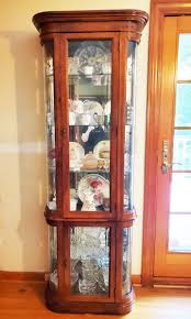 Tall Oak Lighted China Cabinet with Rounded Glass | EstateSales.org