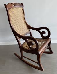 Sold at Auction: Walnut Caned Lincoln Rocker with Carved Rose Back, 20 x 30 x 42 in. (50.8 x 76.2 x 106.7 cm.)
