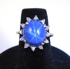 Lot - SYNTHETIC STAR SAPPHIRE AND DIAMOND RING. The 14k