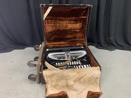 Sold at Auction: Vintage Giulietti Piano Accordion. Model 127, stamped 11003. Year unknown. Works. Leather shoulder strap is broken. Comes with carrying case on wheels