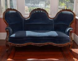 Sold at Auction: A Victorian carved sofa with blue velvet upholstery, the framed carved with roses and foliate motif, Height 109cm x Width 196cm x Depth 84cm