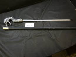 Sold at Auction: Dragon head cane sword, cane is 36", sword is 20"