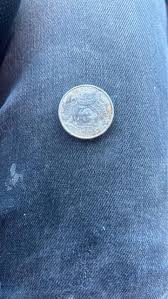 What are the details of the coin found in the basement?