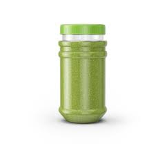 Green herbal powder in cylindrical plastic jar bottle or ...