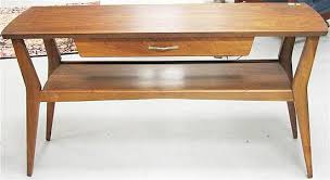 Lot - Mersman mid-century design pair of single drawer end tables, 21 1/2" high x 19 1/2" wide x 31" deep, along with a matching coffee ta...