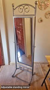 Adjustable standing mirror