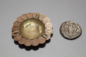 Lot - Metal medallion depicting Greek god Seilenos and Aztec motif brass ashtray encircled by Mexican coins