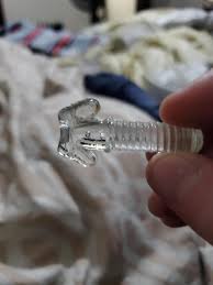 made of glass and threaded like a screw. has two anchor like ...