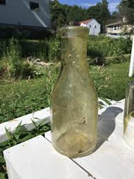 Old quart bottle with bumpy neck (to prevent slipping?). Any idea of manufacture time period? I can't find any similar online. : r/BottleDigging