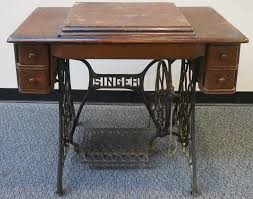 Lot - Singer Wrought Iron Treadle Base Sewing Table with a Burdick Sewing Machine, H Closed: 30 1/2 in. (77.5 cm.)