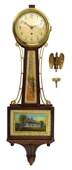 Lot - +Chelsea Banjo clock, C-1947, 8-day spring driven time only movement with platform escapement, serial #498679, (1945-1949) and painted dial with Arabic numerals, marked "Chelsea" on dial. Mahogany case with brass eagl...