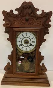 Lot - New Haven walnut Victorian gingerbread clock 23” tall