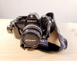 Nikon EM Film Camera With Two Lenses and Some Extras - Shutter Works but Camera Was Not Tested Otherwise - Nice Condition See Pictures - Etsy