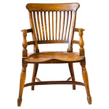 E W Godwin. Attr, An oak armchair with shaped back and a ...