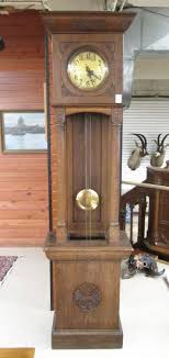 Lot - AN OAK OPEN-WELL TALL CASE FLOOR CLOCK, Schlenker&