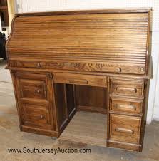 Sold at Auction: Newer solid oak roll top computer desk by Bentwood