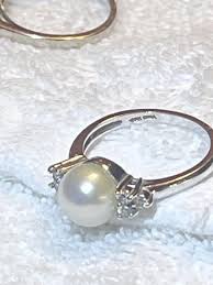 Need help with markers mark on this pearl and diamond ring. I purchased from a reputable jewelers several years ago. I have tried magnifier on my phone. : r/Hallmarks