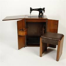 Sold at Auction: Vintage Singer sewing machine in cabinet style table with deco stool.