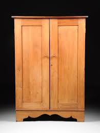 Lot - AN ANTIQUE TEXAS CARVED PINE AND CEDAR WARDROBE, BY GALVESTON CABINETMAKER JOHANN FRIEDRICH AHRENS, BLACK STENCILED MANUFACTURER'S LABEL, THIRD QUARTER 19TH CENTURY,