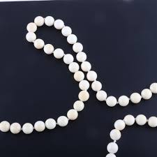 Sold at Auction: Vintage bone pendant necklace with carved flowers and beaded chain and low carat gold bead station.