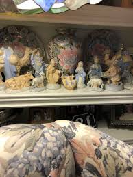 Design a highly detailed 3D-style Nativity scene. Mary, wearing a serene expression, cradles the glowing baby Jesus, while Joseph stands nearby in a reverent pose, his hand resting on his chest. The