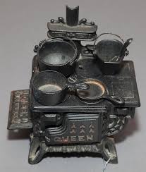 Lot - Black stained iron salesman samplen Queen stove with pots.