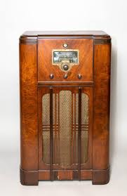 Lot - An Art Deco mahogany radio cabinet, Model #E86. 40 x 24 1/2 x 11 1/2 in. (101.60 x 62.23 x 29.21 cm.)