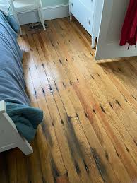 What are the black stains on my old wood floor?
