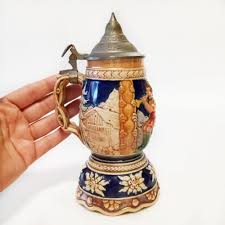 Sold at Auction: Vintage ceramic textured relief German boys and countryside design music box stein with lid