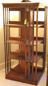 Sold at Auction: Furniture: (2) items: a marked 'Danner's revolving bookcase – John Danner Canton OH' antique walnut open square four-sided shelf with slat ends (no swivel pedestal base) in old natural