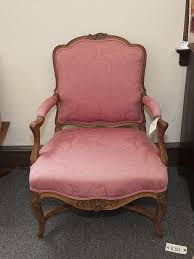 Lot - French provincial style open armchair, with shield form back, on cabriole legs connected by "x" form stretcher