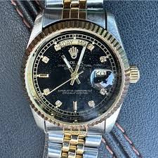 Rolex Black Dial Watch with Gold and Silver Bracelet